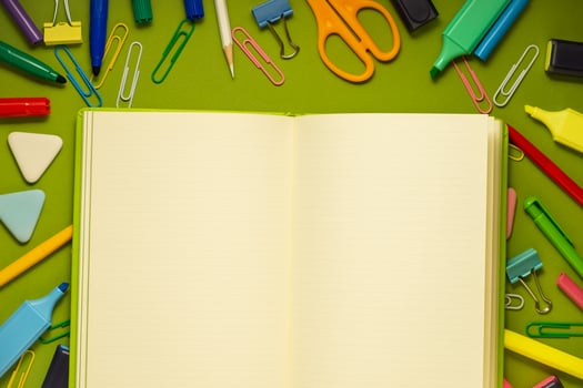 School office supplies on a desk with copy space. Back to school concept. School supplies on green background. Back 2 school concept photo