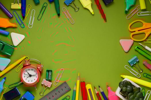 School office supplies on a desk with copy space. Back to school concept. School supplies on green background. Back 2 school concept photo