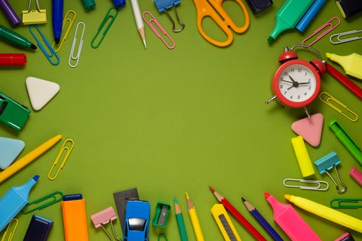 School office supplies on a desk with copy space. Back to school concept. School supplies on green background. Back 2 school concept photo