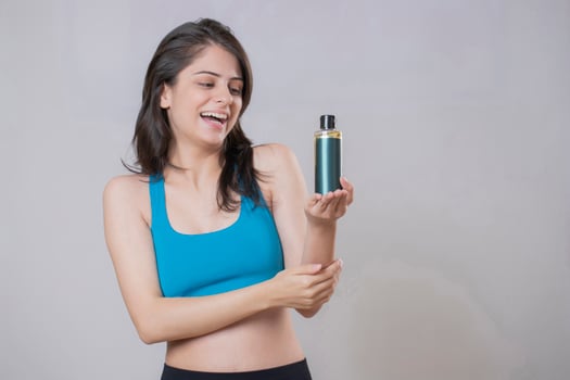 Blonde Girl Holding Oil Bottle In Hand photo