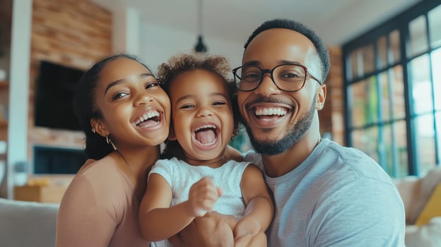 A joyful family poses together in their cozy living room, showcasing happiness and love during a sunny afternoon photo