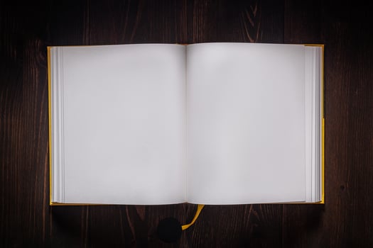 Open book blank on old wooden table. Book with blank pages on dark back. photo