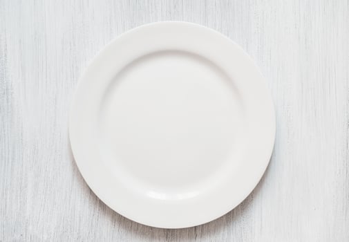 White round plate on white background. Empty white plate on white background. photo