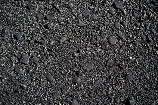An asphalt texture background features a rough, gritty surface commonly seen on roadways photo
