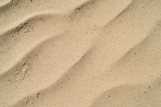 A warm, grainy beach sand texture background evokes a sun-soaked, coastal feel photo