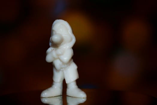 A white statue of a man standing with his arms crossed photo