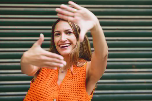 Woman framing with hands smiling at camera photo