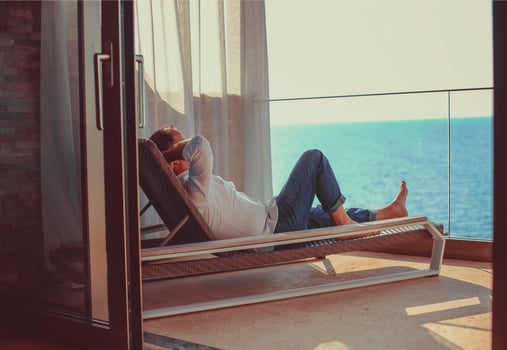 Relaxed young man at home on the balcony photo
