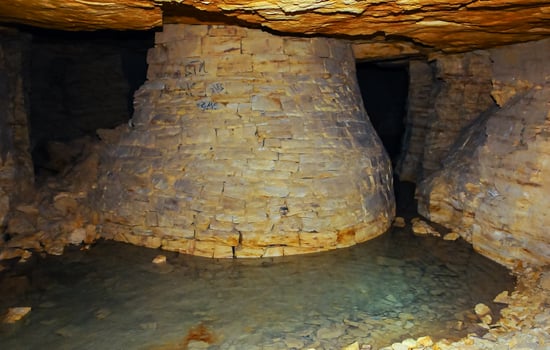 Fortifications in the form of round pear-shaped pillars made of saw shell rock in the Odessa catacombs photo