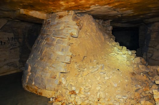 Fortifications in the form of round pear-shaped pillars made of saw shell rock in the Odessa catacombs photo