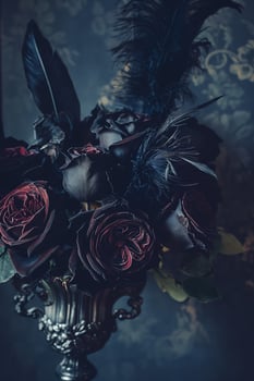 Dark Romantic Floral Arrangement with Black Feathers in Ornate Vase photo