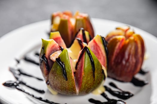 figs baked with cheese camembert or brie fresh meal food snack on the table copy space food background rustic top view keto or paleo diet vegetarian vegan food photo