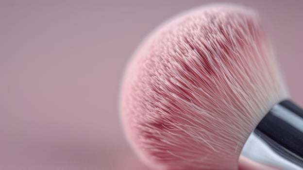 Close-Up of Pink Makeup Brush Against Soft Pink Background photo