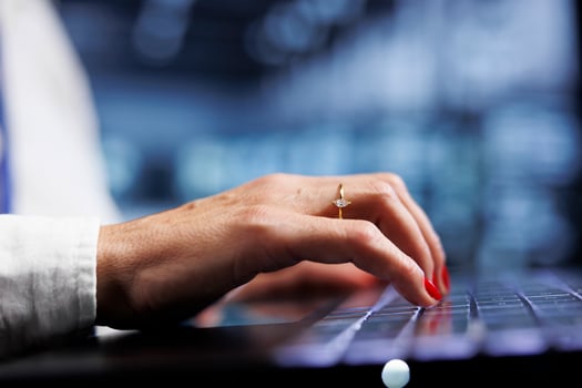 Aged IT professional using laptop, ensuring valuable data remains shielded from potential hazards, safeguarding server rigs against unauthorized access and vulnerabilities, close up photo