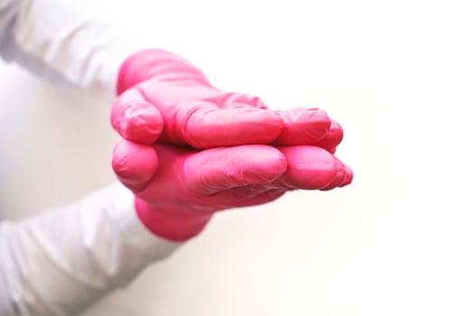 Pray in Medical glove. Surgery doctor hand. Medicine healthcare operation equipment. Specialist clean hospital arm. Sanitation protection gesture. Sterile hygiene concept. Namaste. Pink color photo