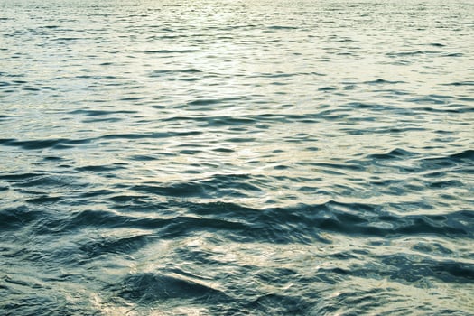 Beautiful water surface with small waves and reflections photo