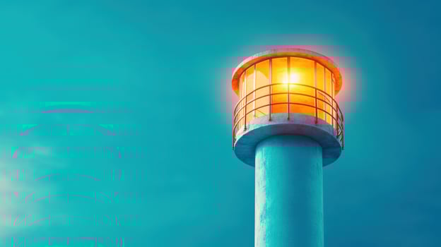 A lighthouse with a glowing light against a vibrant blue sky, symbolizing guidance, hope, and safety for maritime navigation. photo