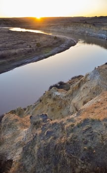 View of the winding river from the mountain in the evening at sunset. North Dakota photo