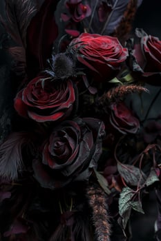 Dark Gothic Bouquet of Red Roses with Feathers and Thorns photo