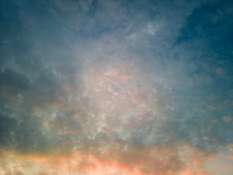 The rays of the sun breaking through the dramatic clouds in the evening or in the morning in the sunset or sunrise sky. photo