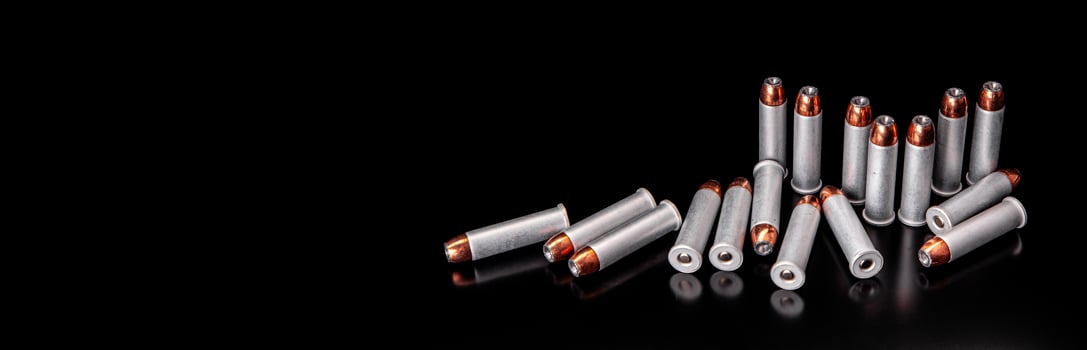 Bullet isolated on black background with reflexion. Rifle bullets close-up on black back. Cartridges for rifle and carbine on a black. photo