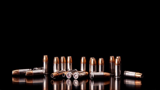 Bullet isolated on black background with reflexion. Rifle bullets close-up on black back. Cartridges for rifle and carbine on a black. photo