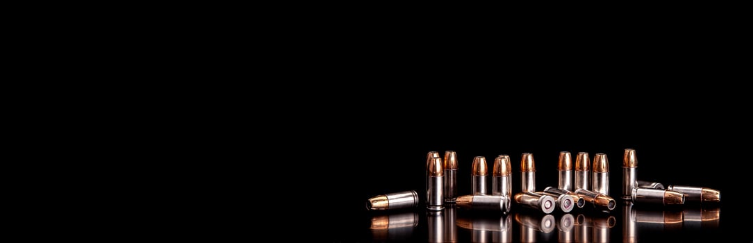 Bullet isolated on black background with reflexion. Rifle bullets close-up on black back. Cartridges for rifle and carbine on a black. photo
