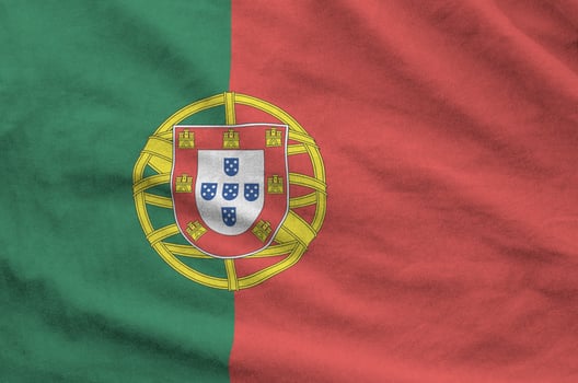 Portugal flag depicted on folded wavy fabric of old cloth photo