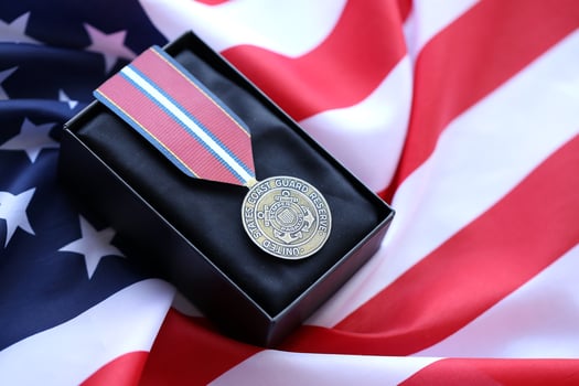 KYIV, UKRAINE - JULY 10, 2024 US Coast Guard Reserve Good Conduct medal. United States military award medal with ribbon and pin. Handmade paper theater props photo