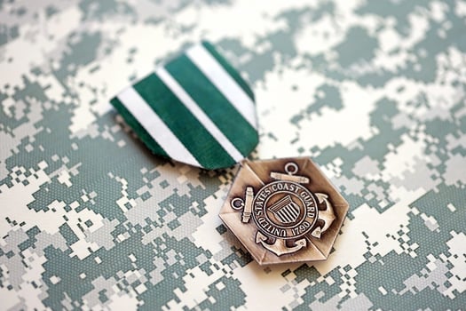 KYIV, UKRAINE - JULY 10, 2024 The Coast Guard Commendation medal. United States military award medal with ribbon and pin. Handmade paper theater props photo