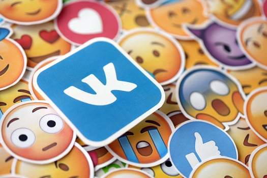 KYIV, UKRAINE - APRIL 20, 2024 VK logo and large set of stickers with Emoji yellow faces. Emoji is a pictogram or smiley embedded in text and used in electronic messages photo