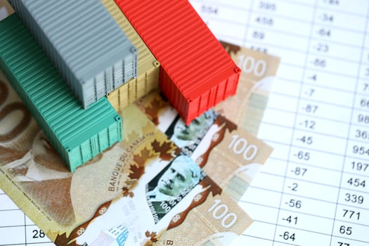 Company shipping cargo containers in Canada with dollar money bills and pen photo