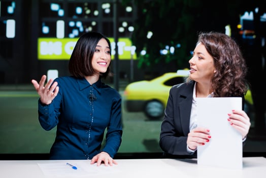 Journalists team open night show discussion in newsroom, delivering important topics with exclusive information. Diverse women presenting celebrity drama and creating tv content. photo