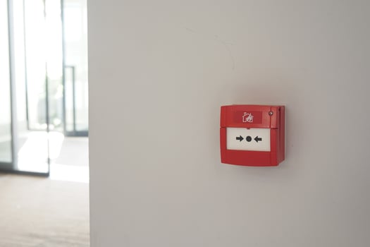 Red fire alarm button on wall , photo