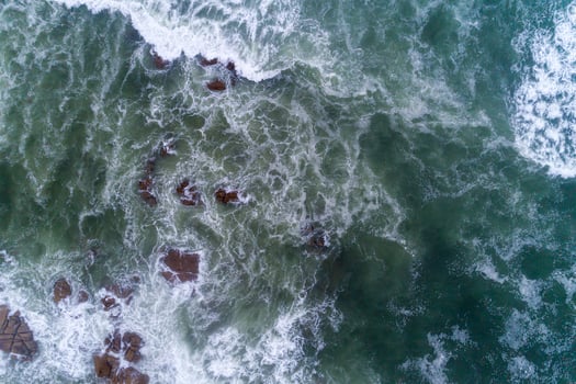 drone aerial view of the seashore with rough seas on a rocky shore photo