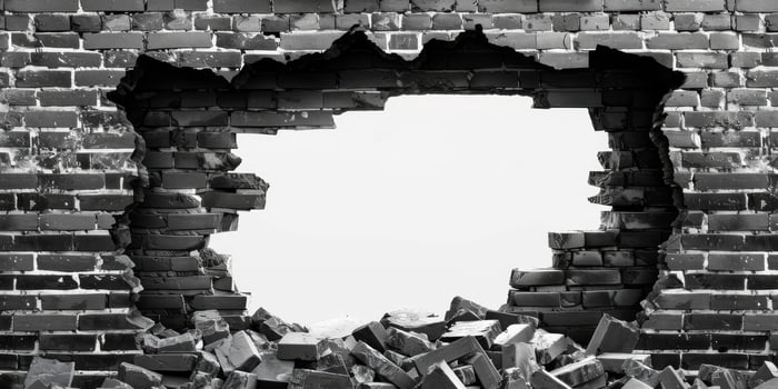 This black and white image features a large hole in a weathered brick wall, revealing stark space beyond. The intricate texture enhances the scene, compellingly drawing the viewers gaze photo