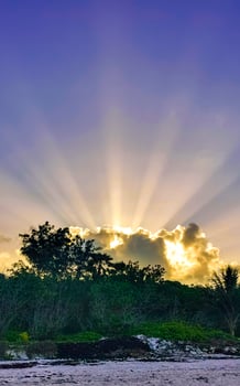 Amazing sunbeams sun rays sunset sunrise tropical Caribbean jungle Mexico. photo