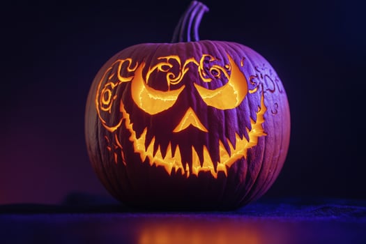 A beautifully carved pumpkin radiates a warm glow, showcasing intricate designs perfect for autumn celebrations. photo