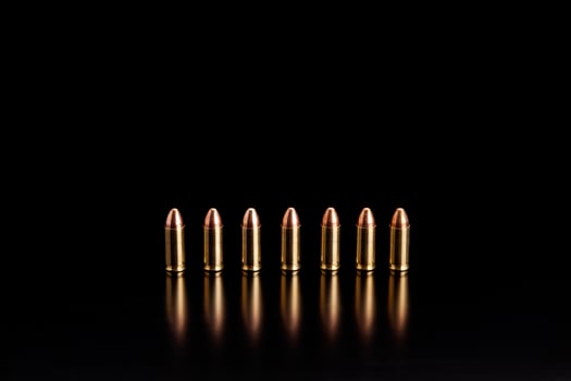 Bullet isolated on black background with reflexion. Rifle bullets close-up on black back. Cartridges for rifle and carbine on a black. photo