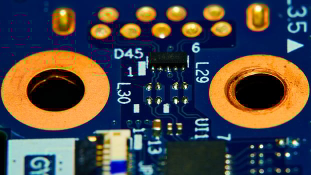 a close up of a computer motherboard with a few holes photo
