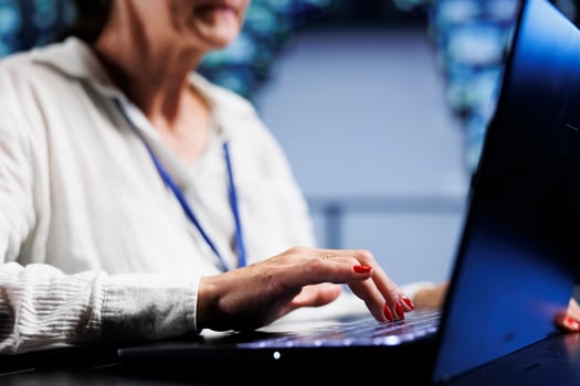 Precise serviceman using laptop, ensuring valuable data remains shielded from security menaces, safeguarding high tech facility servers against unauthorized access and vulnerabilities, close up photo