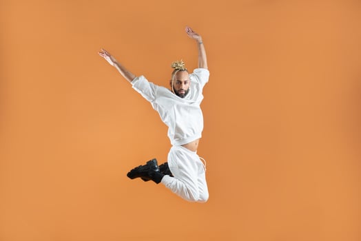 Gay man dancing isolated on orange photo