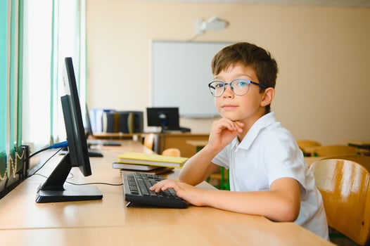 Little schoolboy during lesson in classroom photo