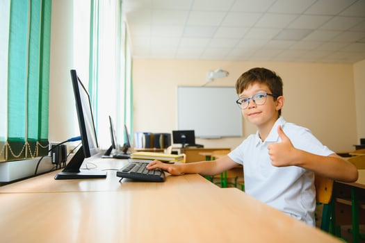 Little schoolboy during lesson in classroom photo