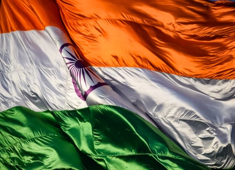 India flag flying high at Connaught Place with pride in blue sky, India flag fluttering, Indian Flag on Independence Day and Republic Day of India, tilt up shot, Waving Indian flag, Har Ghar Tiranga photo