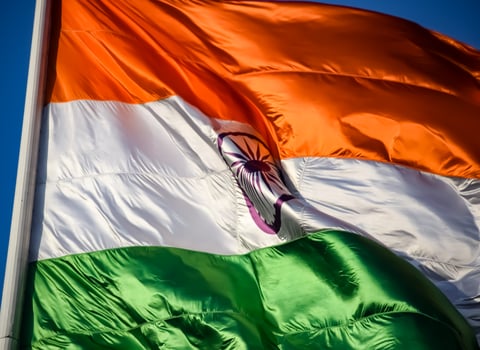 India flag flying high at Connaught Place with pride in blue sky, India flag fluttering, Indian Flag on Independence Day and Republic Day of India, tilt up shot, Waving Indian flag, Har Ghar Tiranga photo