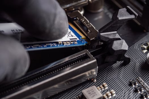a specialist installs a solid-state drive in the m2 connector photo