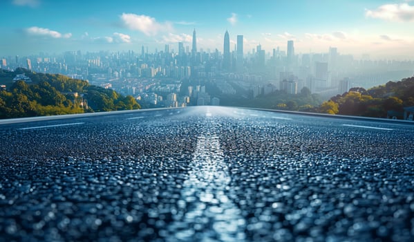 Scenic view of an empty road leading towards a city skyline at dawn. An empty road stretches ahead photo