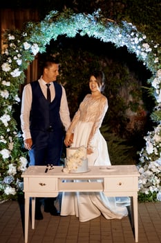 newlyweds happily cut and taste the wedding cake photo