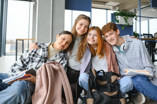 Happy diverse college students posing for group portrait, looking at camera, smiling photo